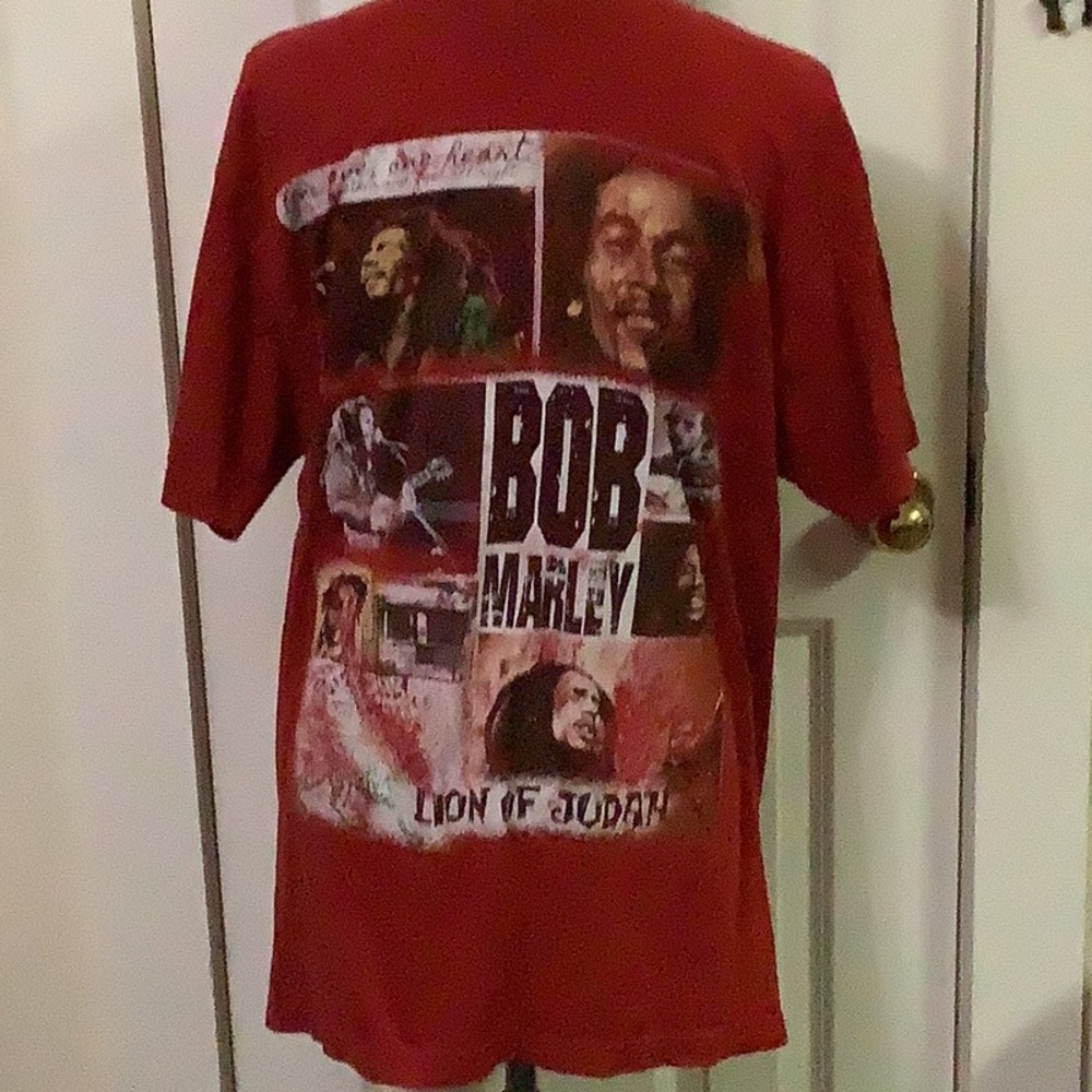 Bob Marley tee shirt.  1970 s. With pictures of him at different ages on front.